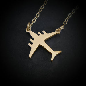 C-17 Globemaster necklace in 14k gold pendant on black background