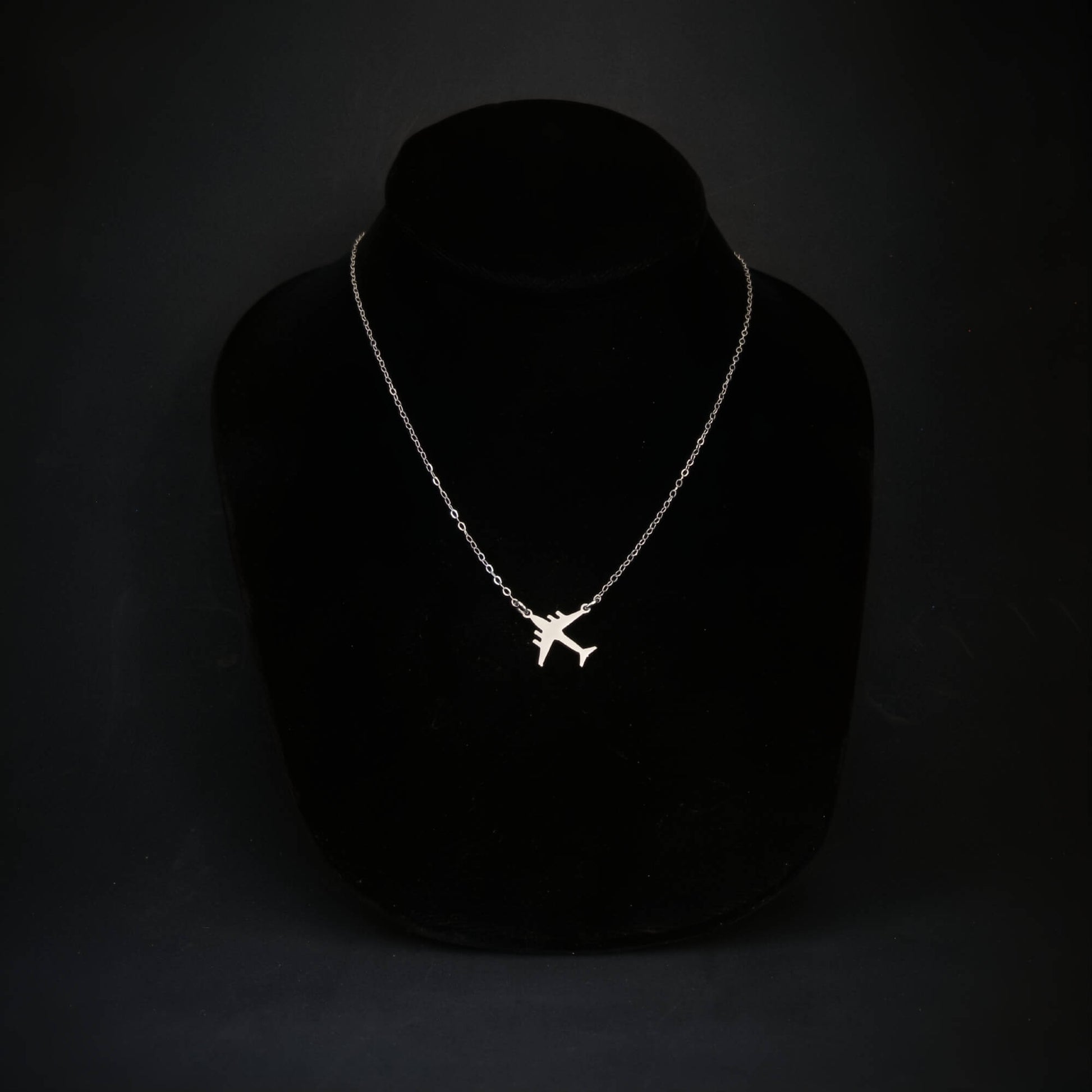 Sterling silver C-17 jet pendant necklace displayed on black bust