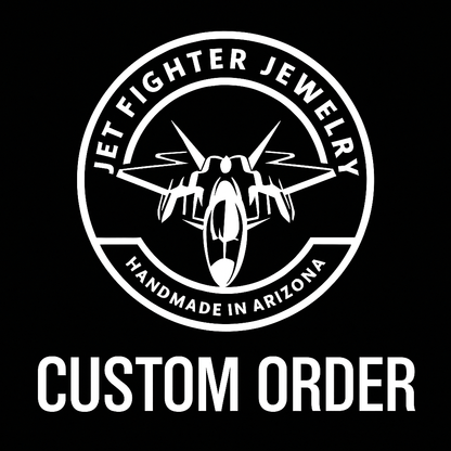 Logo of Jet Fighter Jewelry with a fighter jet and text 'Handmade in Arizona' on a black background.