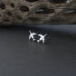 Sterling Silver E-3 Sentry military jet airplane shaped stud earrings on a dark background with driftwood