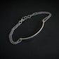 Silver chain bracelet on a black background