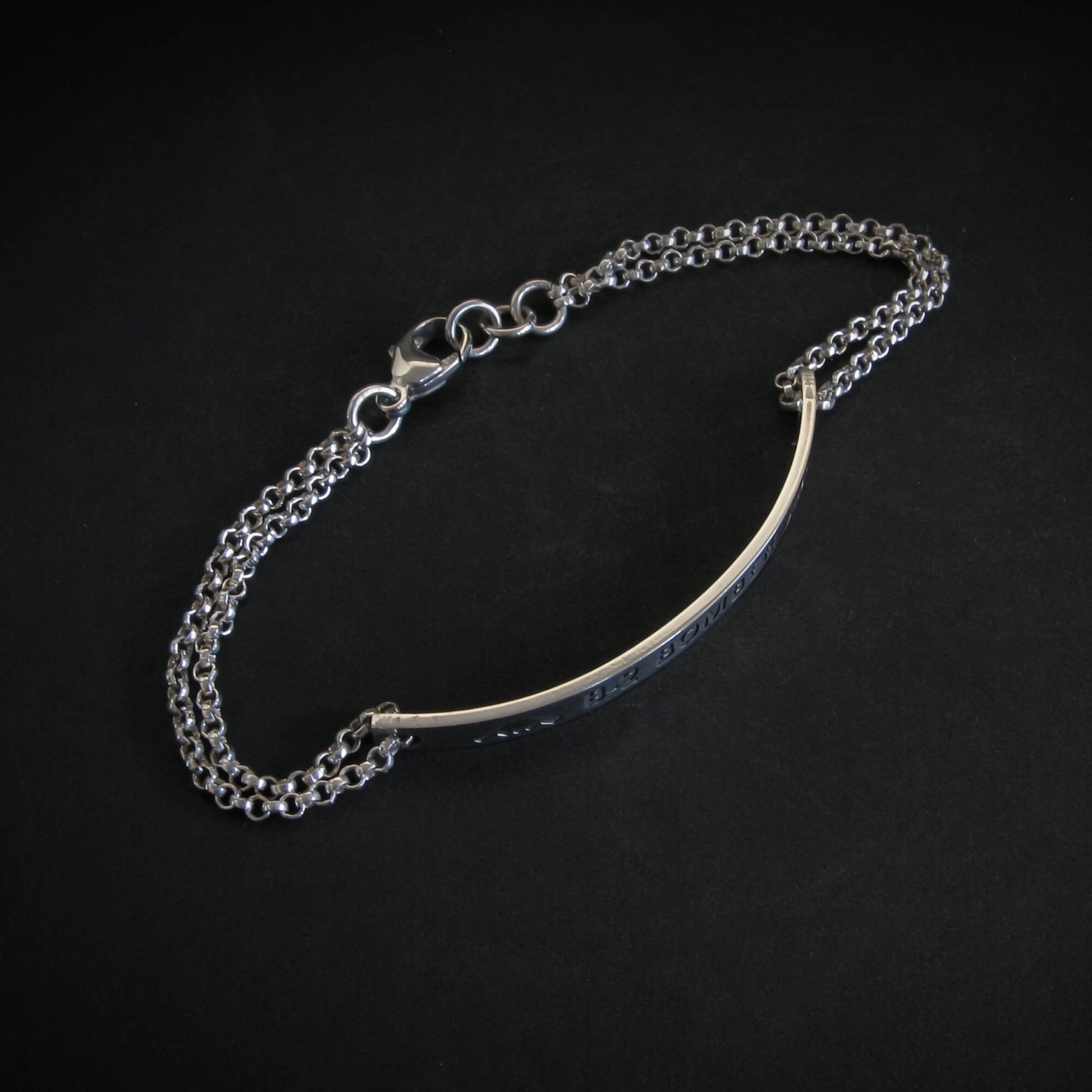 Silver chain bracelet on a black background