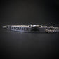 Silver bracelet with 'B-2 Bomber' engraving on a dark background