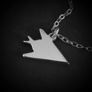 Close-up of sterling silver F-117 Nighthawk stealth jet pendant necklace – handmade air force aviation jewelry