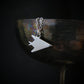 Sterling silver F-117 Nighthawk stealth jet pendant necklace displayed on wine goblet – handcrafted aviation jewelry photography
