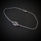 Silver bracelet with a round tag featuring an F-16 military fighter jet on a black background