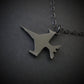 Dark sterling silver F-16 jet airplane-shaped pendant on a chain against a dark background