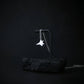 Sterling silver F-22 Raptor necklace draped on a black display with dark minimalist background