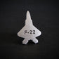 Silver F-22 military aviation fighter jet tie tack on a black background