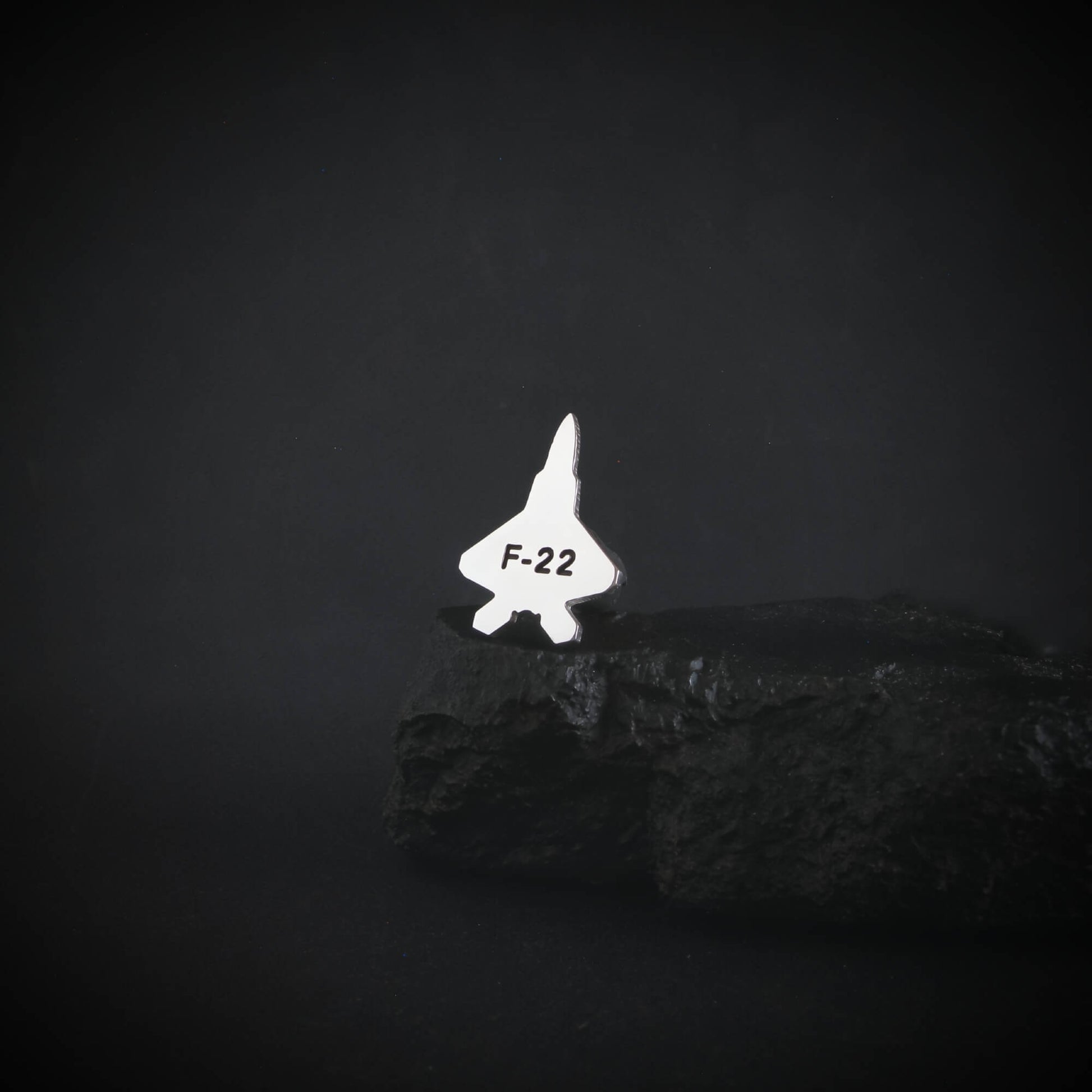 F-22 fighter jet  sterling silver military aviation tie tack on a dark background