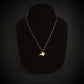 14k Gold F-35 Military Fighter Jet pendant on a chain against a black necklace bust and background
