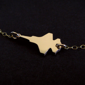 F-35 Military Fighter Jet Inline Necklace in 14k Gold against a dark background