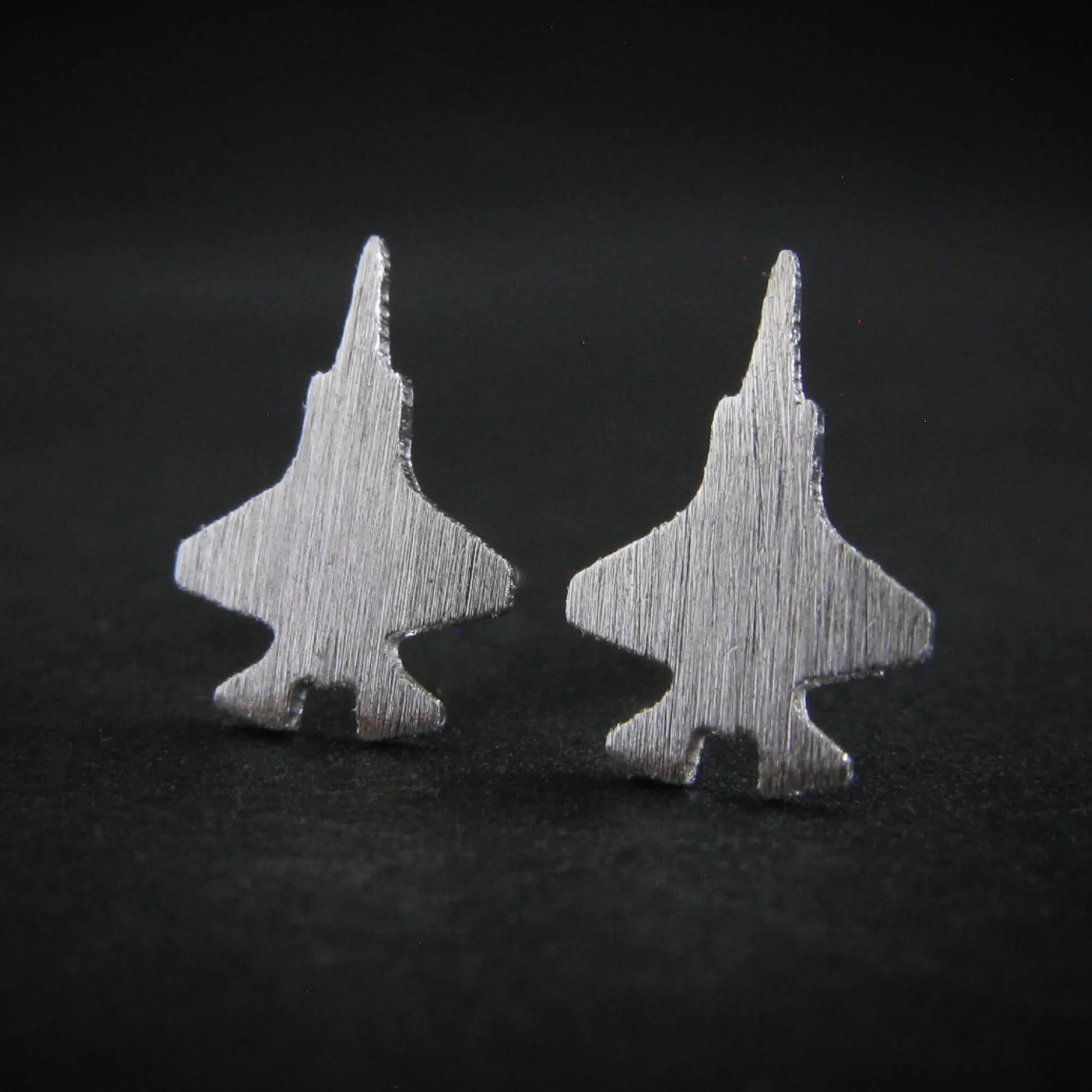 Matte-finished F-35 jet silhouette stud earrings with a brushed texture