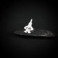 Silver F-35 silver tie pin jet airplane on a dark stone surface with a black background