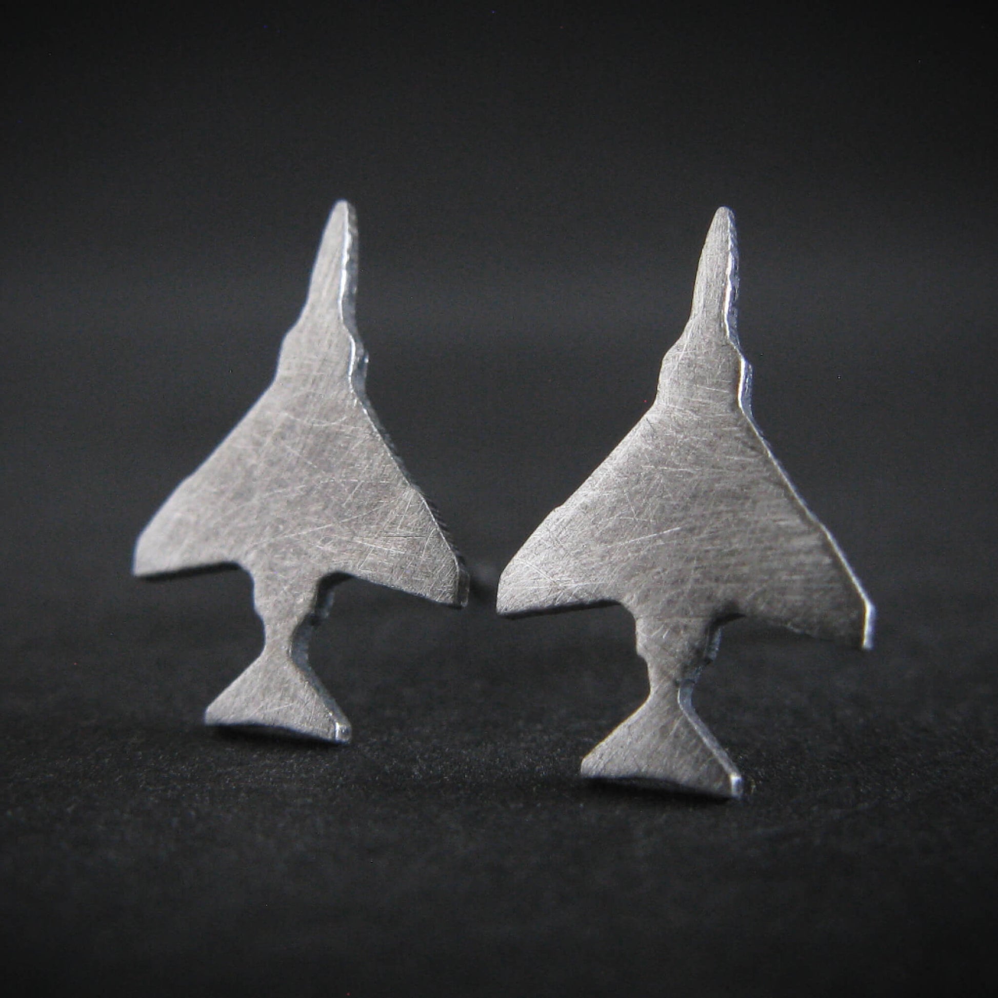 Antiqued Sterling Silver F-4 Phantom Military Jet airplane shaped earrings on a black background