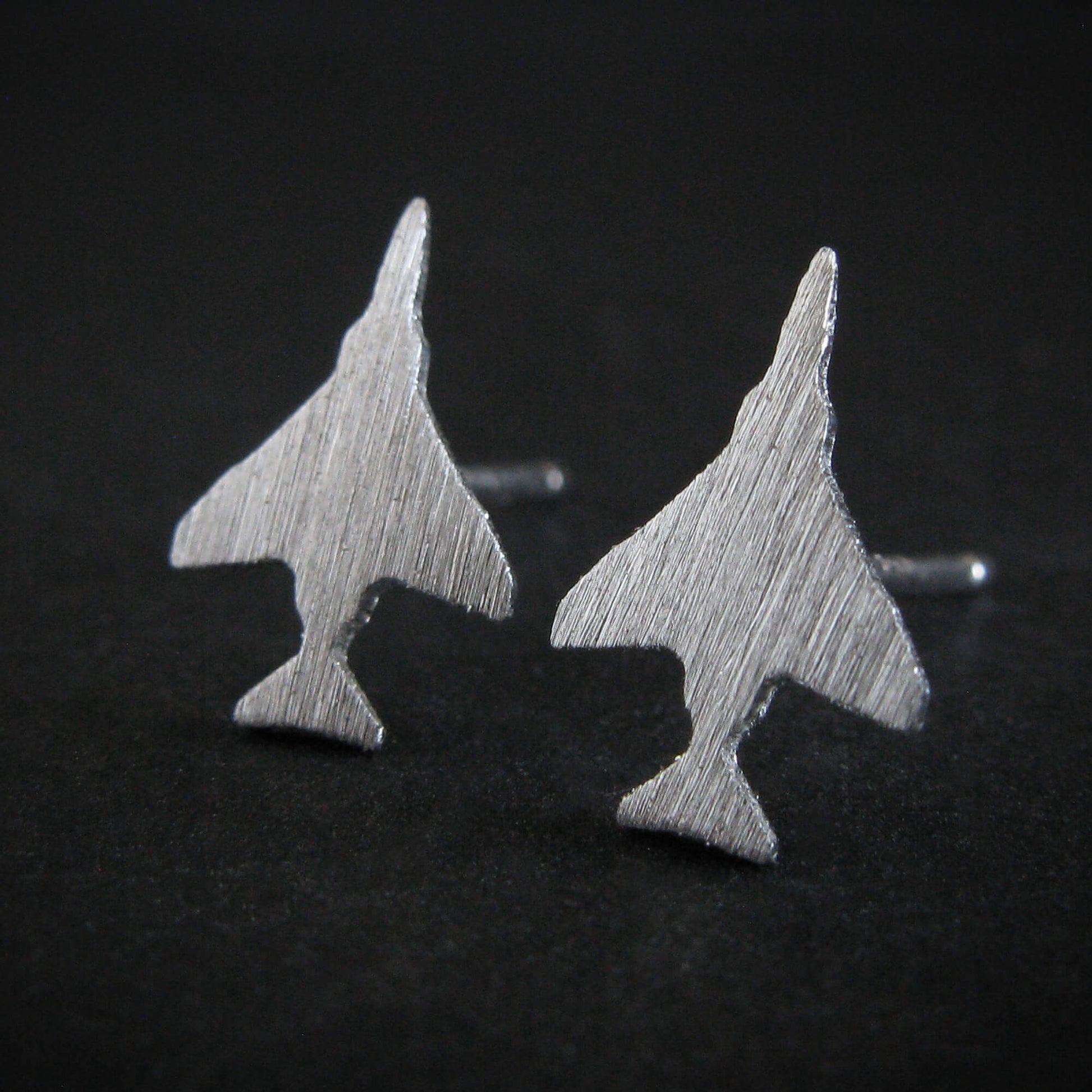 Brushed Sterling Silver F-4 Phantom Military Jet airplane shaped earrings on a black background