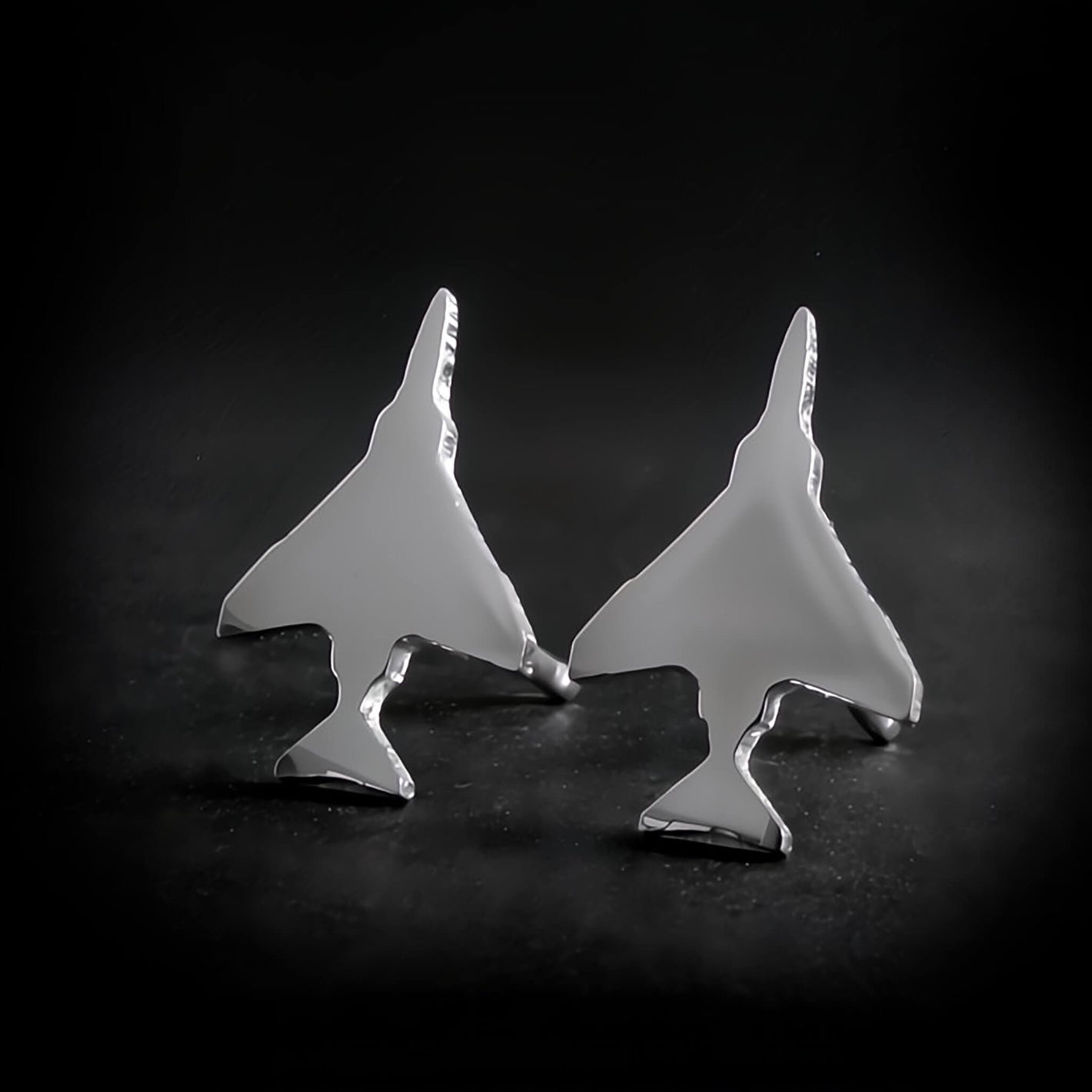 Polished Sterling Silver F-4 Phantom Military Jet airplane shaped earrings on a black background