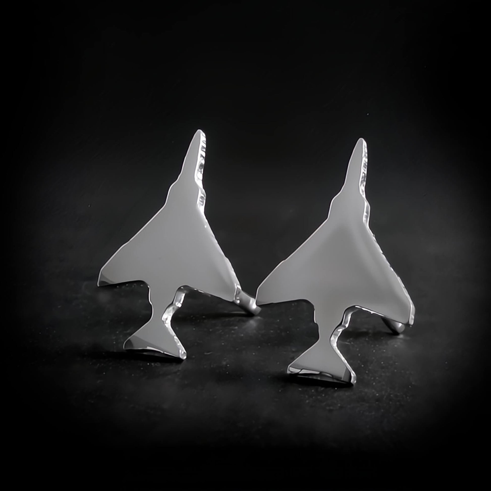 Polished Sterling Silver F-4 Phantom Military Jet airplane shaped earrings on a black background