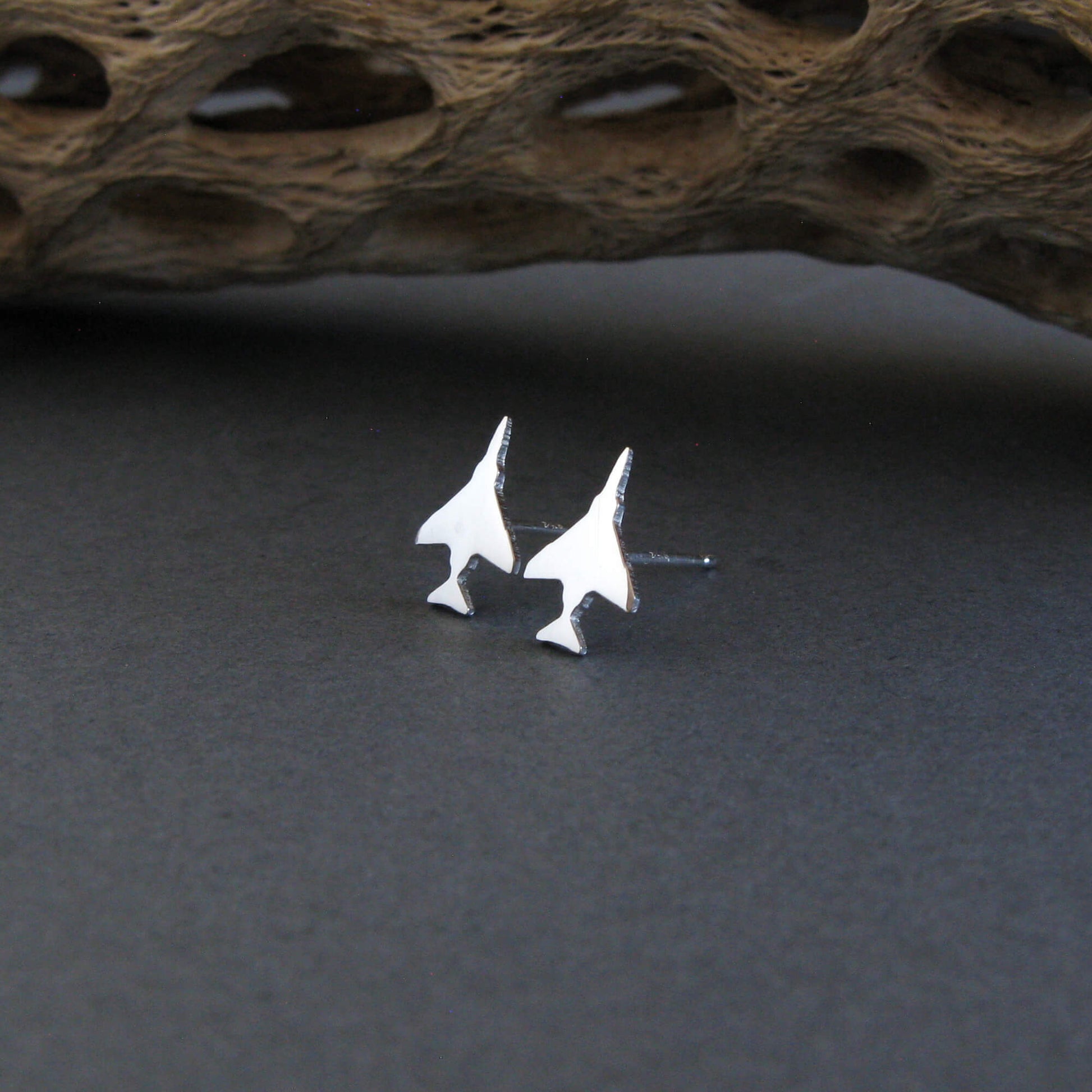 Antiqued Sterling Silver F-4 Phantom Military Jet airplane shaped earrings on a natural background