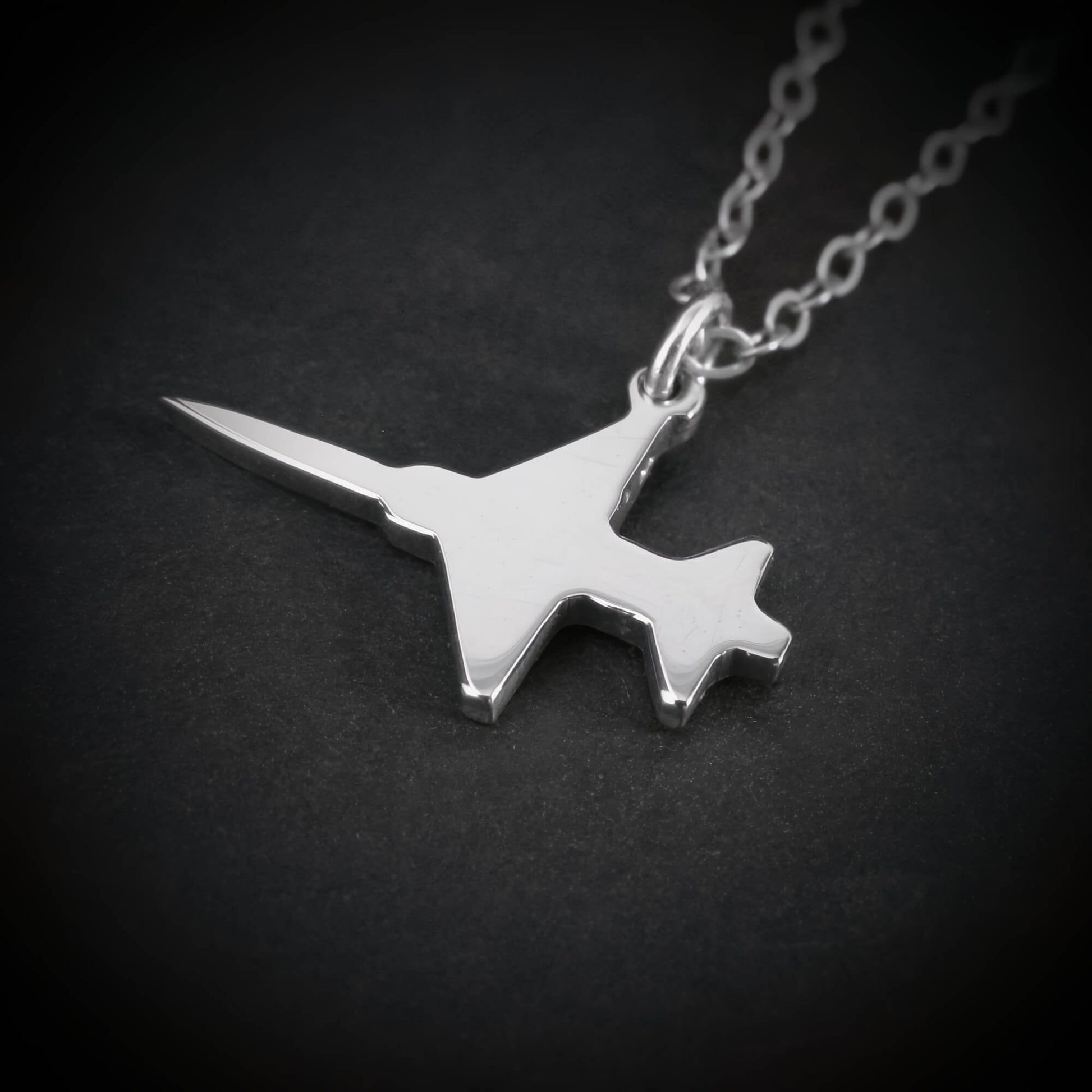 Close-up of sterling silver F-5 Freedom Fighter airplane pendant necklace – handmade aviation and military jewelry
