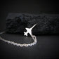 Sterling silver F-5 Freedom Fighter airplane pendant necklace displayed on black rock – artisan aviation jewelry handmade in USA