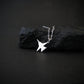 Sterling silver F-14 Tomcat jet fighter pendant necklace displayed on black rock, handcrafted aviation jewelry