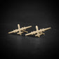 14k gold stud earrings in the shape of the MQ-9 Reaper military drone, handcrafted with precision aircraft detailing, set against a dark background.