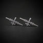 Antiqued sterling silver stud earrings shaped like the MQ-9 Reaper military drone, featuring a matte, vintage-style finish and handcrafted detailing, displayed on a dark background.