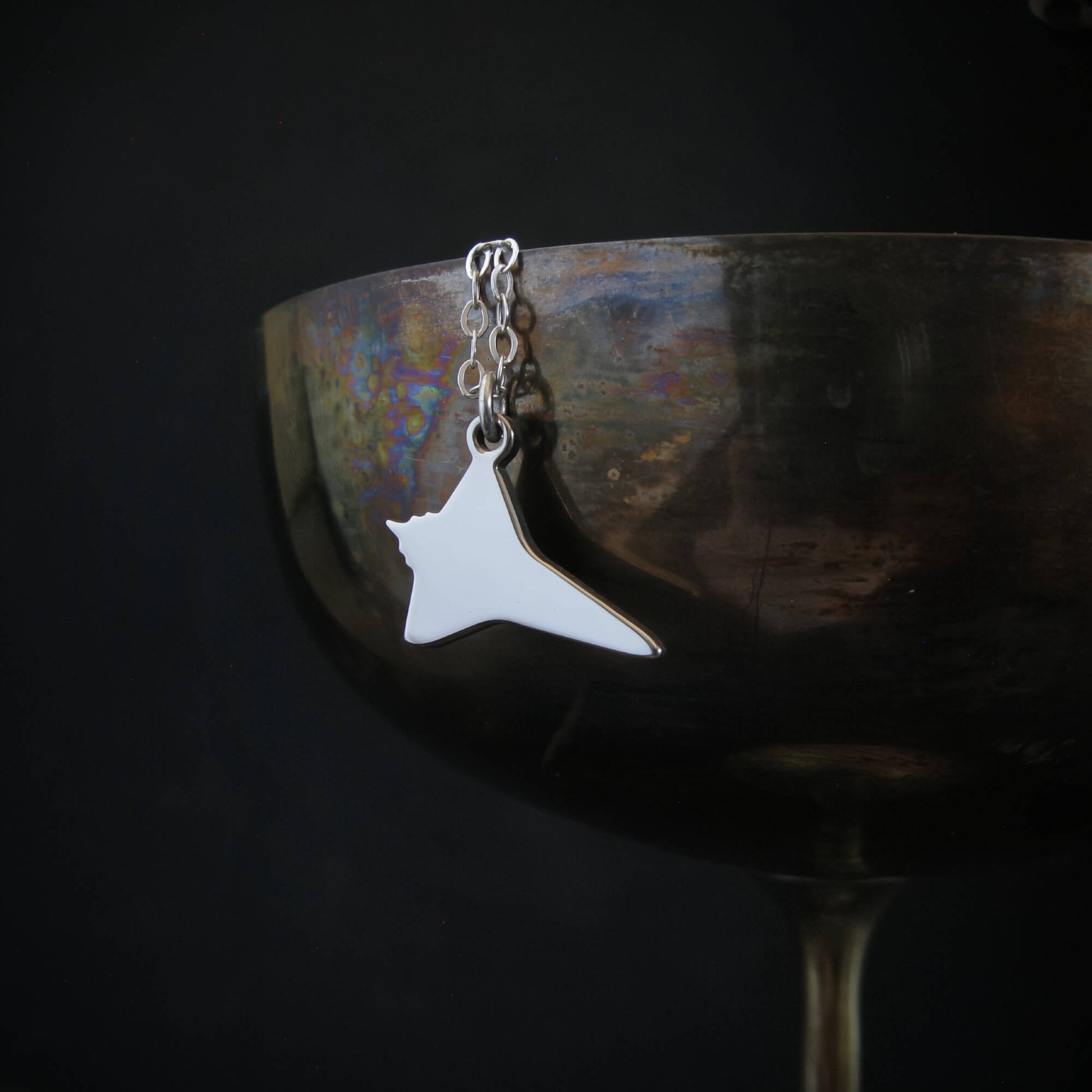 Sterling silver NASA Space Shuttle pendant necklace displayed on wine goblet – handcrafted aviation jewelry