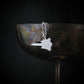 Sterling silver SR-71 Blackbird aircraft pendant necklace draped on wine goblet aviation jewelry