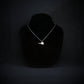Sterling silver SR-71 Blackbird jet pendant necklace displayed on black bust, handmade aviation jewelry