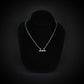 SR-71 Blackbird jet silhouette necklace in sterling silver displayed on black jewelry bust