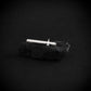 Sterling silver F 16 motif tie bar on a black rock with a black background