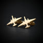 Gold U-2 Dragon Lady military airplane shaped cufflinks on a black background