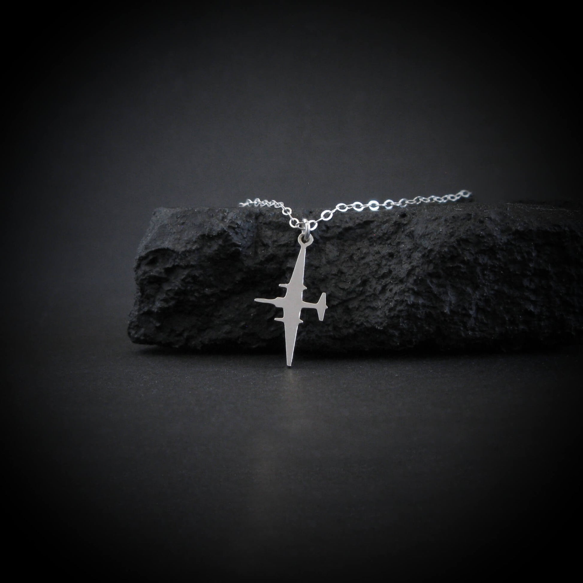 U-2 Dragon Lady airplane pendant in sterling silver styled on textured black rock
