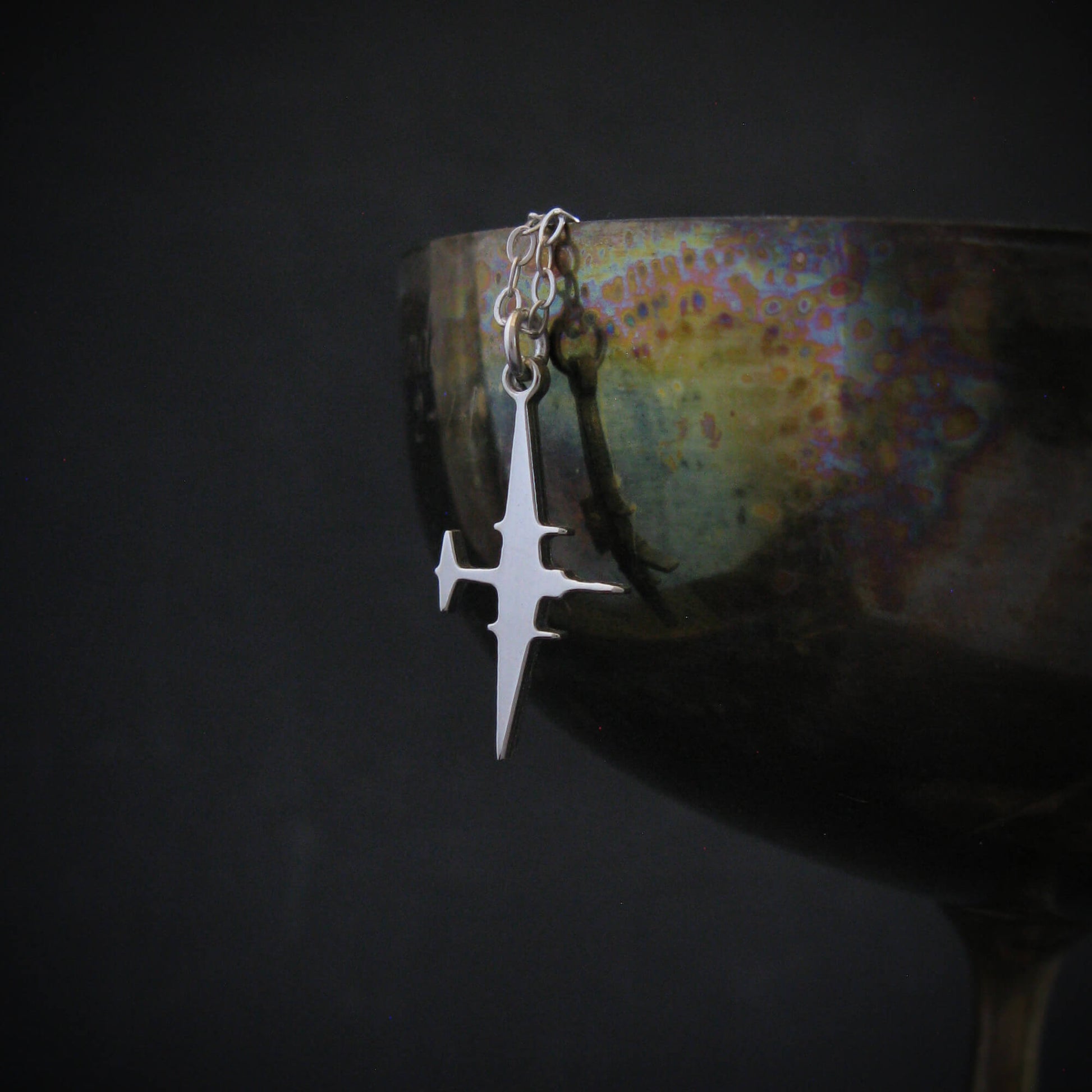 U-2 Dragon Lady reconnaissance jet pendant in sterling silver displayed on wine glass
