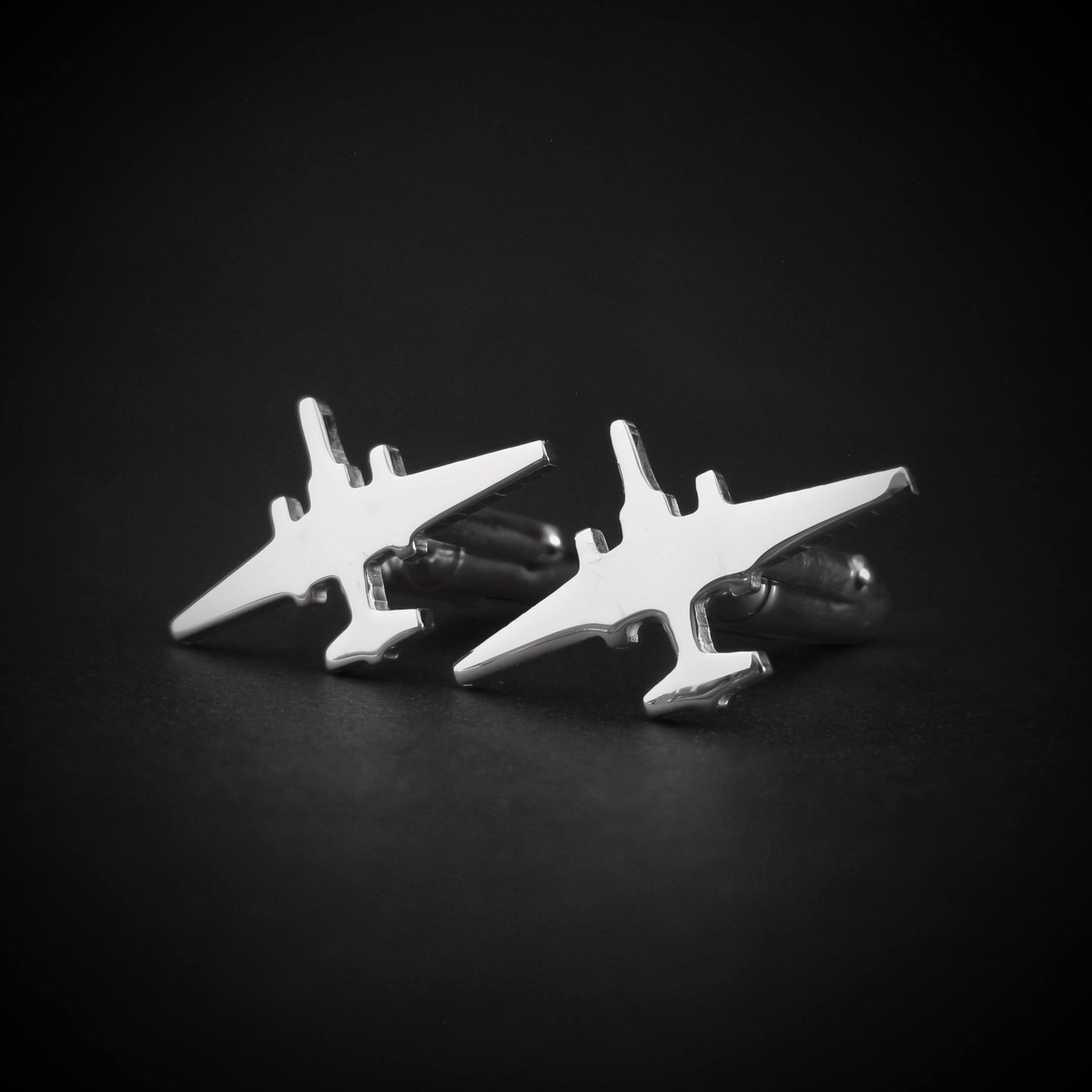 Silver U-2 Dragon Lady Military airplane shaped cufflinks on a black background