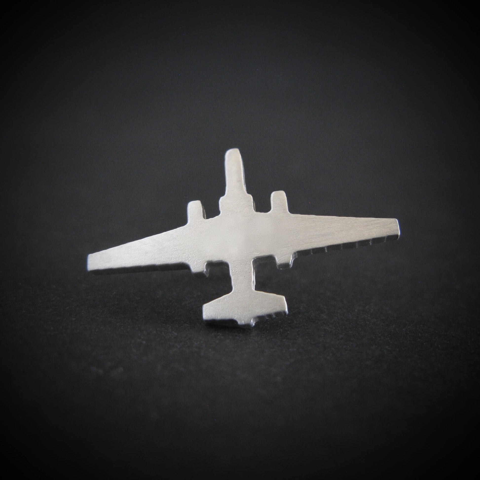 Silver U-2 Dragon Lady military jet airplane tie tack on a black background