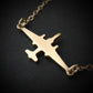 U-2 Dragon Lady military jet pendant necklace in polished 14k gold, displayed close-up against a dark background.