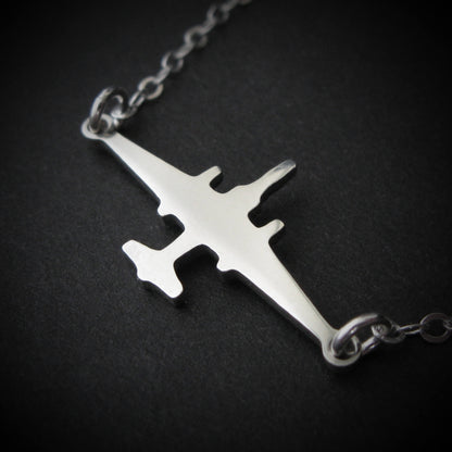 U-2 Dragon Lady military jet pendant necklace in polished sterling silver, displayed close-up against a dark background.