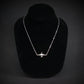 U-2 Dragon Lady military jet pendant necklace in sterling silver, displayed on a black jewelry bust against a dark background.