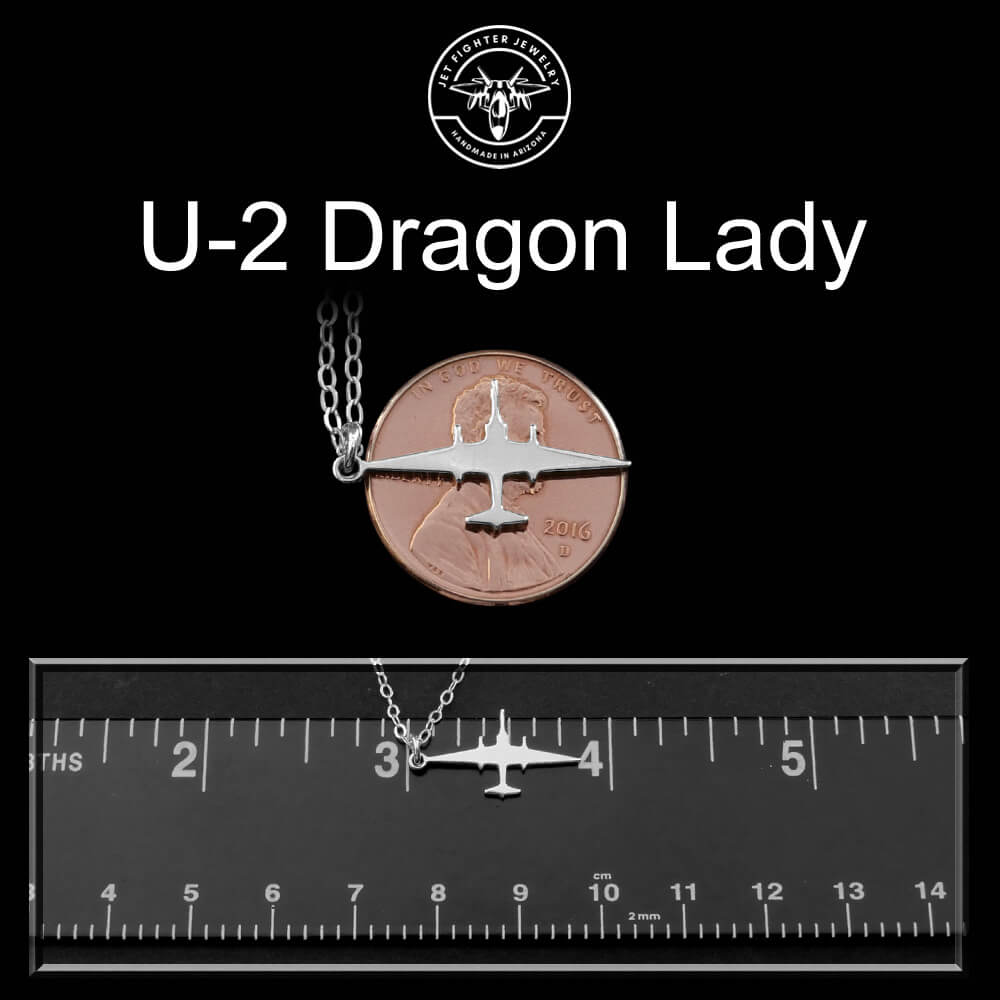 U-2 Dragon Lady necklace on a black background with a ruler for scale.