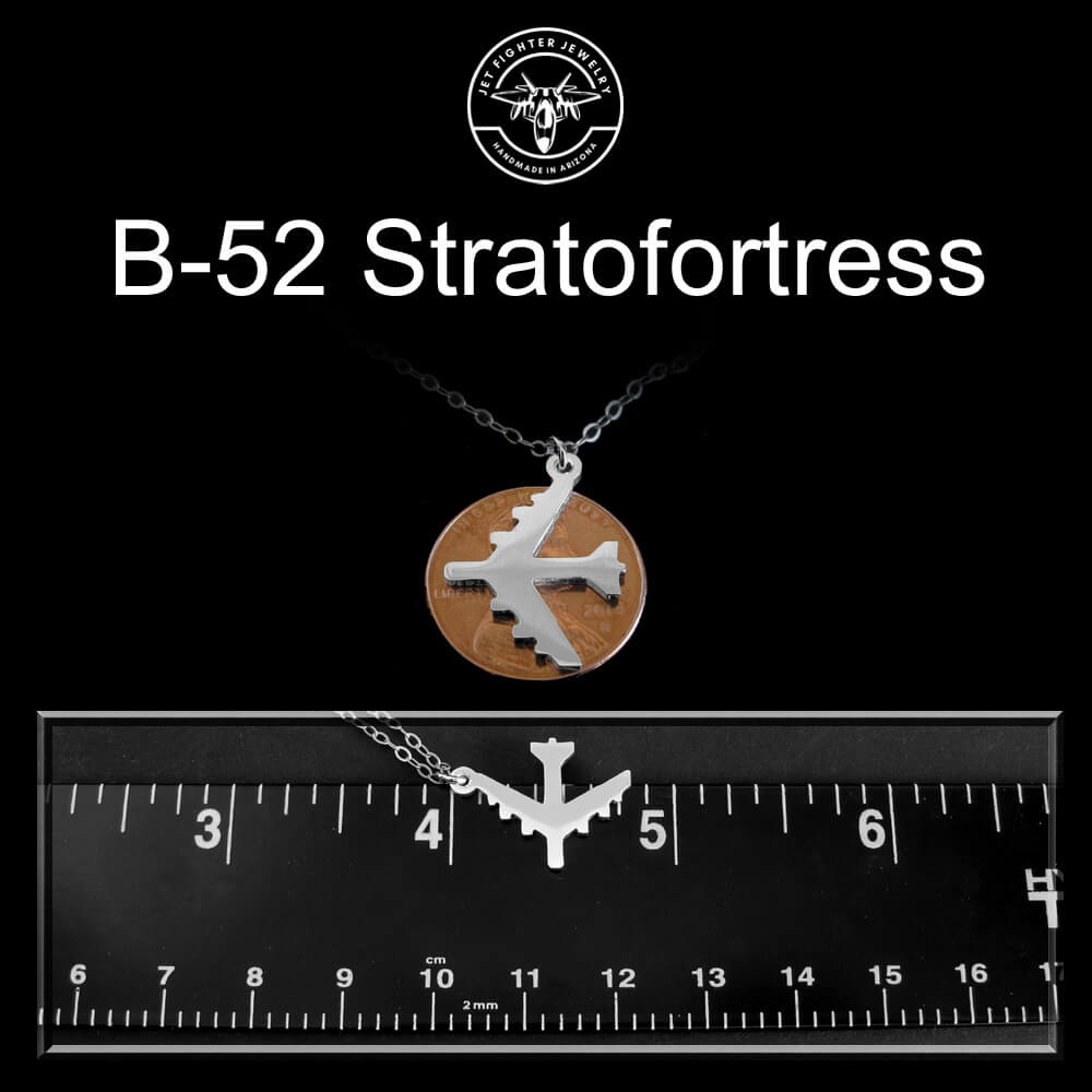 B-52 Stratofortress necklace with ruler for scale on a black background