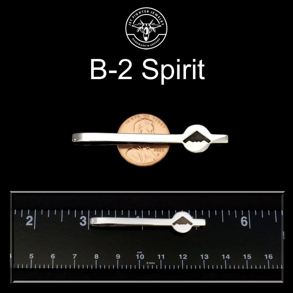 Silver tie clip with a penny for scale on a black background, featuring 'B-2 Spirit' branding.