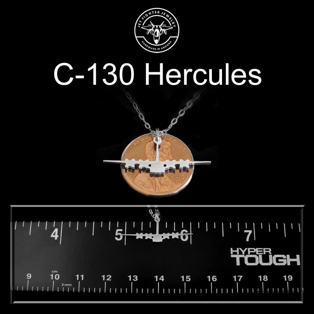 Sterling silver C-130 Hercules necklace on a black background with a penny and ruler for size reference.