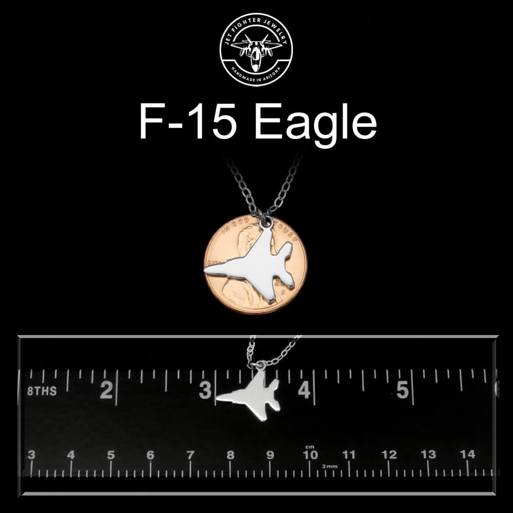 F-15 Eagle necklace with a ruler for scale on a black background