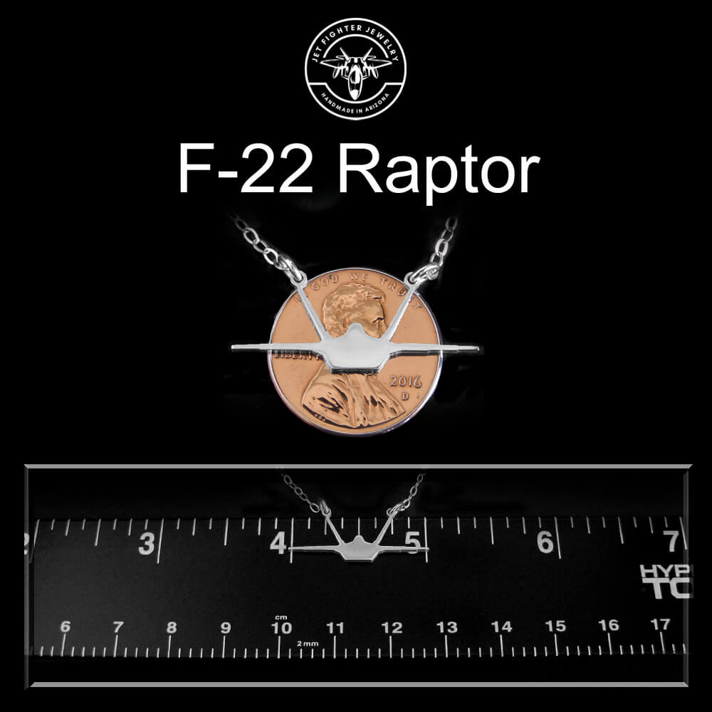 F-22 Raptor sterling silver necklace front silhouette with a ruler for scale on a black background