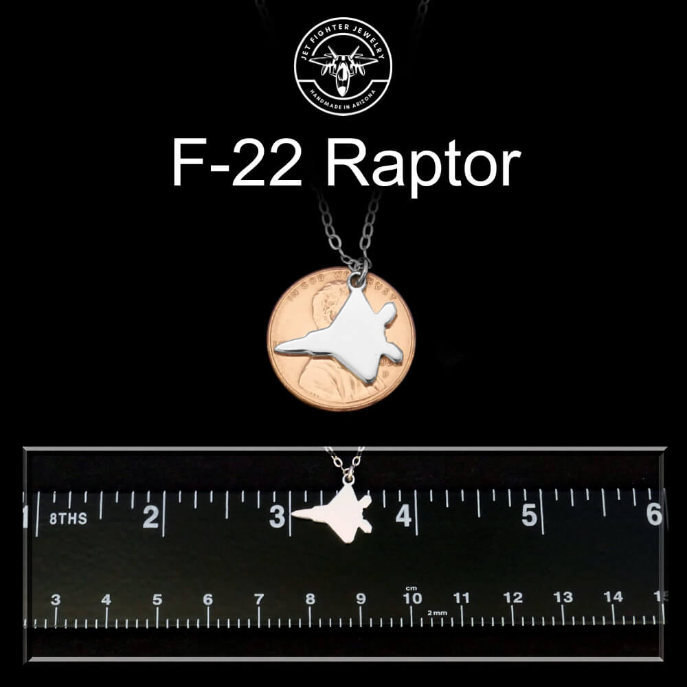 F-22 Raptor necklace with a ruler for scale on a black background