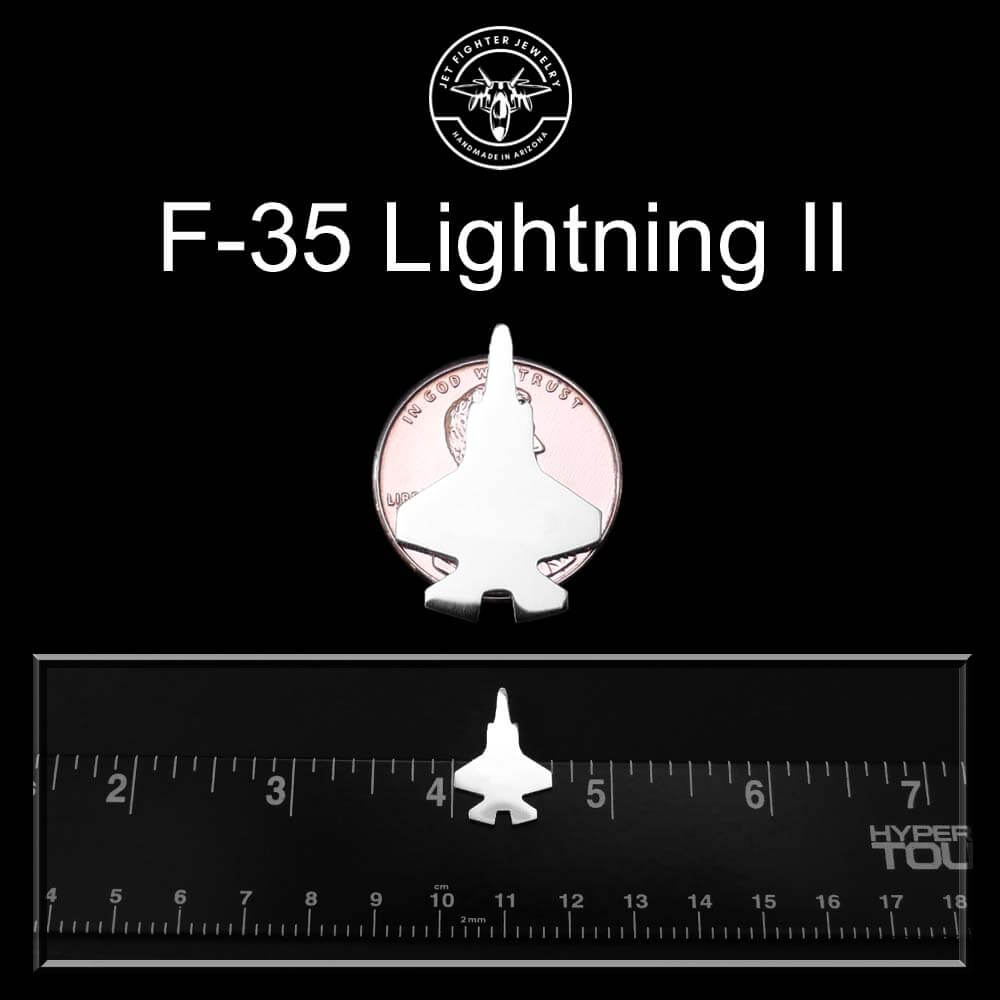 sterling silver F-35 tie pin on a penny and ruler for size reference