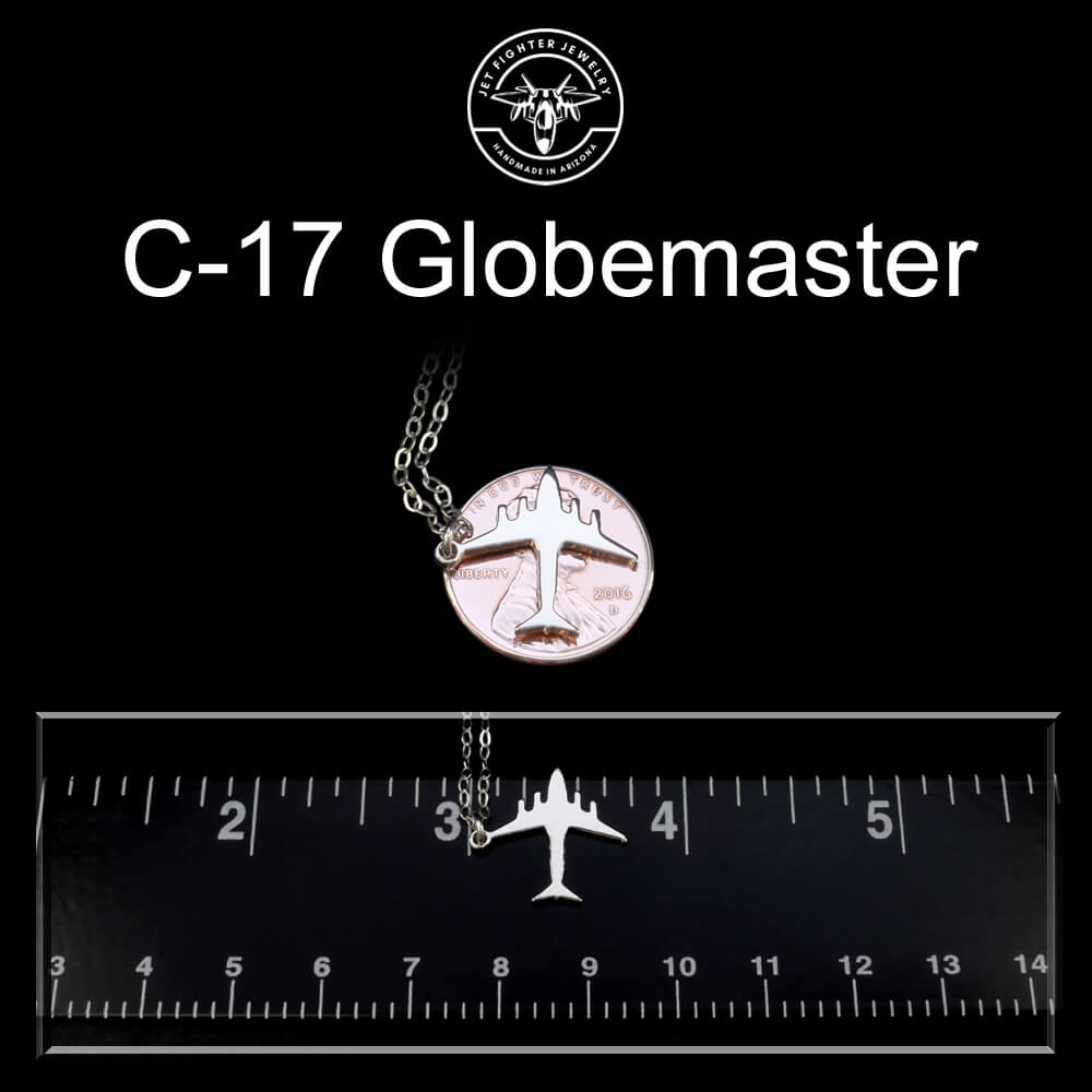 C-17 Globemaster necklace with airplane pendant on a black background with a ruler for scale